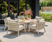 Modern outdoor patio with furniture and a pool in a garden setting