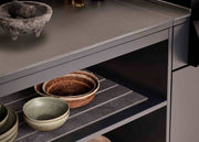Shelves with ceramic plates and bowls in a kitchen setting