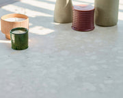 Decorative items including vases and candles on a textured neolith stone surface